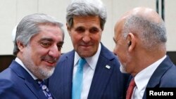 U.S. Secretary of State John Kerry (center) talks with Afghan President Ashraf Ghani (right) and Chief Executive Abdullah Abdullah during a NATO meeting in Brussels on December 2.