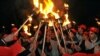 Young people hold torches during a rally in Yerevan on February 27 marking the 24th anniversary of the so-called 1988 Sumgait Massacre of Armenians by Azerbaijanis. (AFP/Karen Minasyan)