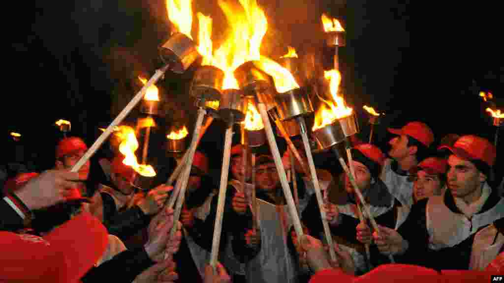 Young people hold torches during a rally in Yerevan on February 27 marking the 24th anniversary of the so-called 1988 Sumgait Massacre of Armenians by Azerbaijanis. (AFP/Karen Minasyan)