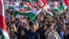 Hungarian opposition leader and president of the Tisza (Respect and Freedom) party Peter Magyar (center) waves a Hungarian flag during a campaign rally organized by Hungary's Tisza party in Budapest on March 15.