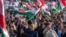 Hungarian opposition leader and president of the Tisza (Respect and Freedom) party Peter Magyar (center) waves a Hungarian flag during a campaign rally organized by Hungary's Tisza party in Budapest on March 15.