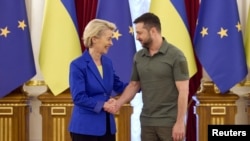 European Commission chief Ursula von der Leyen and Ukrainian President Volodymyr Zelenskiy shake hands before a meeting on September 15. 