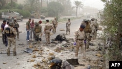 For the fourth year in a row, Iraq was ranked as the world's least-peaceful country. Here, Iraqi troops inspect the scene of a car bombing in Baghdad on June 7.