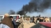 Smoke rises from a bomb blast during a funeral ceremony in Jalalabad on December 31.