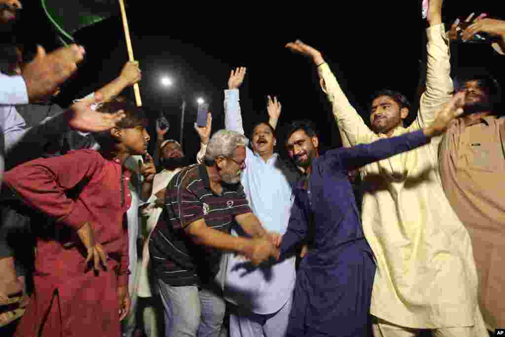 Opposition supporters celebrate the success of a no-confidence vote against Prime Minister Imran Khan in Karachi, Pakistan, early on April 10. Pakistan&#39;s political opposition ousted the country&#39;s embattled prime minister in a no-confidence vote on April 9, which they won after several of Khan&#39;s allies and a key coalition party deserted him.
