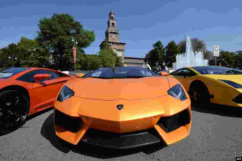 Lamborghini sports cars are parked in front of Milan's Sforza Castle on the eve of the first leg of a 1,200-kilometer grand tour through Italy to mark the 50th anniversary of the carmaker. (AFP/Olivier Morin)