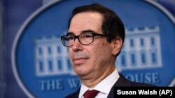 The Democratic senators sent a letter to Treasury Secretary Steven Mnuchin (pictured) asking him to "immediately" place sanctions on a range of Russians. (file photo)