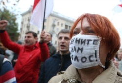 Opposition supporters shout slogans during a rally in Minsk on October 10, 2015.