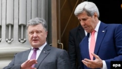 Ukrainian President Petro Poroshenko (left) walks with U.S. Secretary of State John Kerry during their meeting in Kyiv on July 7.