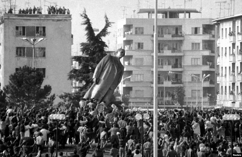 A bronze statue of Albanian dictator Enver Hoxha is toppled after the country&#39;s anti-communist revolution, which began in 1990. &nbsp;
