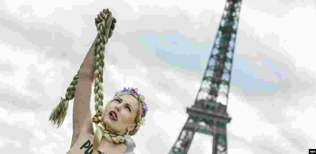 A topless activist from the Femen movement protests against the situation in Ukraine and newly freed opposition icon Yulia Tymoshenko, who they claim is Russian President Vladimir Putin's Puppet. (epa/Etienne Laurent)