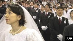 Religious authorities in a number of post-Soviet states, including Russia, have harshly criticized the Unification Church, whose members are seen here in a mass wedding in Seoul in 2002, calling it a sect.