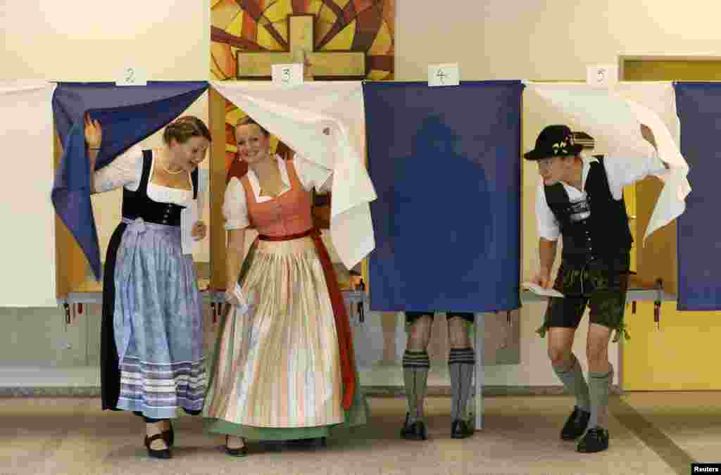 German voters wearing traditional Bavarian dress cast their ballots in the country's general election at a polling station in Gaissach. (AFP/Patrik Stollarz)