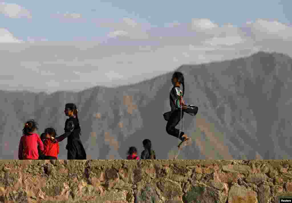 An Afghan girl jumps rope on a hilltop in Kabul. (Reuters/Mohammad Ismail)