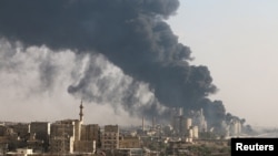 Smoke rises from a Syrian regime-controlled cement factory in Aleppo on August 9.