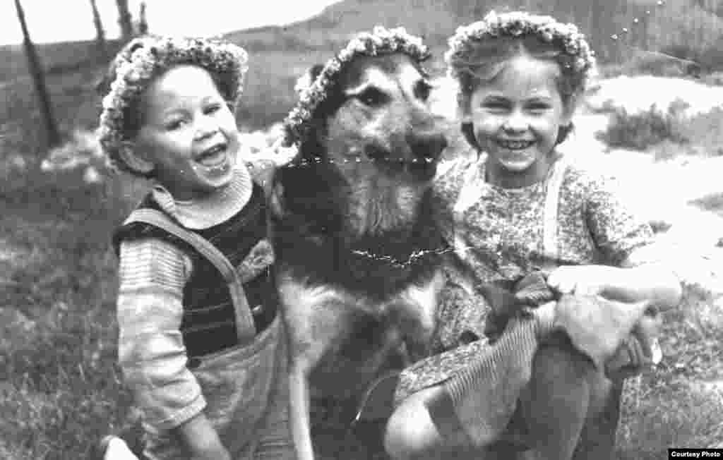 Even the wear-and-tear evident on some old photos holds stories. Solomia Lebid, an engineer in Lviv, remembers her grandmother Myroslava as an avid photographer and an equally avid seamstress. Sometimes the two hobbies inadvertently crossed paths, as in this picture of two neighboring children with Myroslava's dog, which shows marks of the tracing wheel Myroslava used with her sewing patterns. 