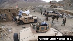 FILE: Afghan soldiers patrol in restive Achin district in August 2017.