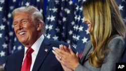 President-elect Donald Trump stands on stage with his wife, Melania Trump, at an election night watch party in Palm Beach, Florida, on November 6.