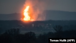 A column of fire is seen after an explosion ripped through Austria's main gas pipeline hub in Baumgarten on December 12.