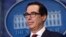 The Democratic senators sent a letter to Treasury Secretary Steven Mnuchin (pictured) asking him to "immediately" place sanctions on a range of Russians. (file photo)