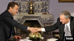 Russian Prime Minister Dmitry Medvedev (left) shakes hands with visiting Cuban leader Raul Castro as they meet in the Gorki residence on July 11.