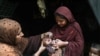 A health worker administers polio drops to a child during a door-to-door vaccination campaign in Lahore, Pakistan, on October 28.