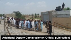 FILE: Voters queued to cast votes in Pakistani general in North Waziristan tribal district on July 25, 2018.