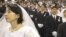 Religious authorities in a number of post-Soviet states, including Russia, have harshly criticized the Unification Church, whose members are seen here in a mass wedding in Seoul in 2002, calling it a sect.