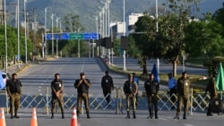 Police officers stand guard at a closed road leading to the Serena Hotel at the Red Zone area in Islamabad on April 22. The fate of US-Iran talks in the city remain uncertain.