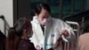 China - checking someone's status at a checkpoint - lockdown restriction of movement - coronavirus COVID screen grab