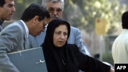 Abdolfattah Soltani (left) speaking with his colleague, the Nobel Prize-winning human rights lawyer Shirin Ebadi, in Tehran in 2004