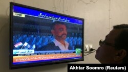 PAKISTAN - A man looks at television screen, airing live transmission of released Indian pilot Wing Commander Abhinandan, at Wagah border, in Karachi, on March 1.