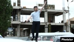 Armenia - A man brandishes a gun outside a court building in Yerevan, 12Jun2014.