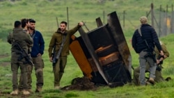 Israel -- Israeli security personnel secure an area around a rocket 