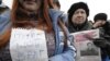 Opposition supporters attend a rally of protest in Vladivostok. The sign reads, "Putin Is My Enemy."