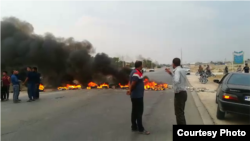 Protesters in Borazjan township in Iran block a roadway by burning tires. November 16, 2019