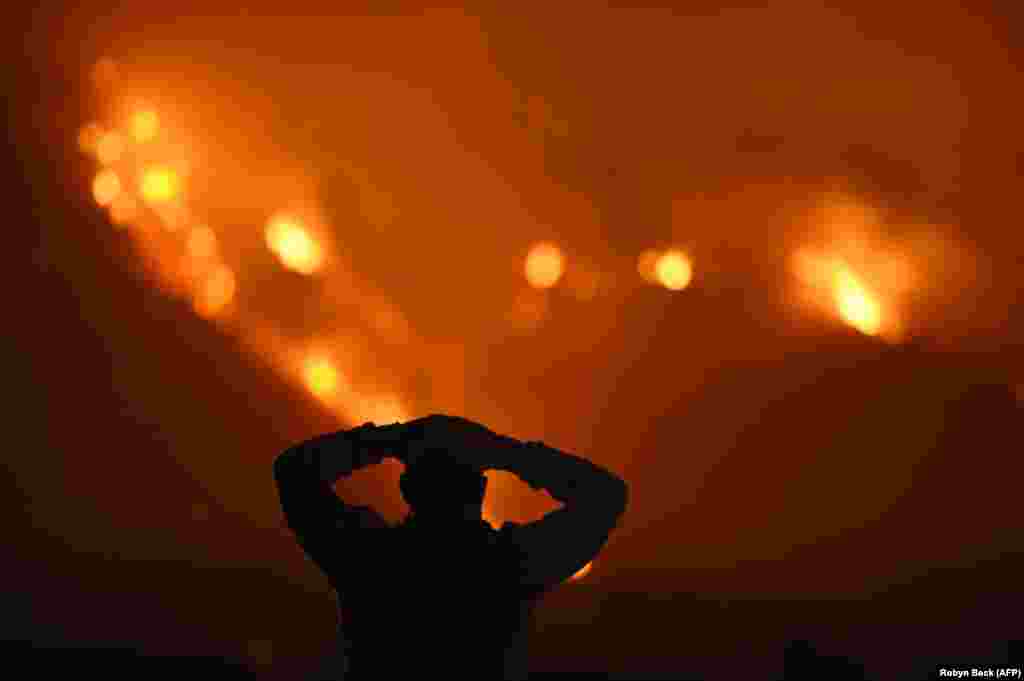 A man watches the Thomas Fire in the hills above Carpinteria, California, on December 11. The Thomas Fire in California's Ventura and Santa Barbara counties has consumed more than 93,000 hectares over the past week, making it the fifth-largest fire in the state's history. (AFP/Robyn Beck)