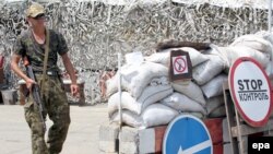 A pro-Russian separatist mans a checkpoint 25 kilometers from the rebel stronghold of Donetsk on July 23.