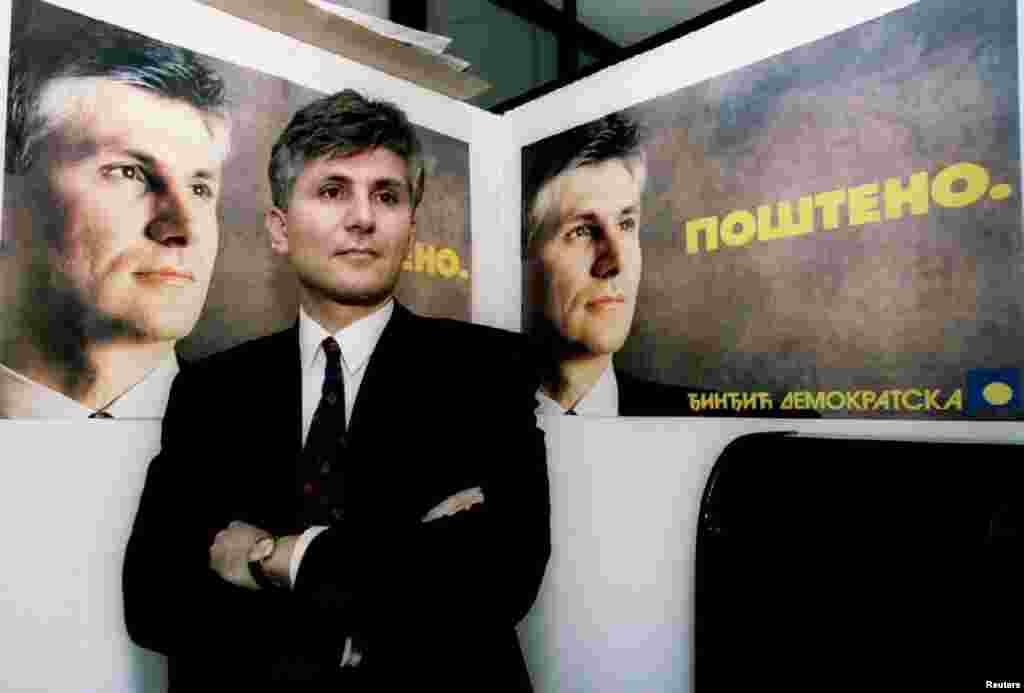 Zoran Djindjic, the leader of Serbia&#39;s Democratic Party, which he helped found, poses in front of election posters with the slogan &quot;Fair&quot; on December 23, 1993.