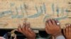 Men in the Iraqi city of Najaf carry the coffin of a relative killed in an election-day attack. - Iraqi Prime Minister Nuri al-Maliki has <a href="http://www.rferl.org/content/PM_Maliki_Leads_Iraq_Vote_In_Two_Provinces/1981001.html><b>emerged as the front-runner</a></b> after the March 7 election, which was marred by accusations of fraud and outbreaks of violence in a number of cities.
<br /><br />Photo by Qassem Zein for AFP