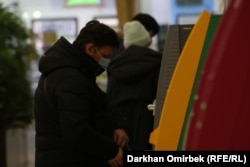 kazakhstan a man withdrawing cash from atm, Nur-Sultan, 23 January 2021