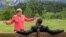 German Chancellor Angela Merkel (left) gestures while chatting with U.S. President Barack Obama sitting on a bench outside the Elmau Castle after a working session of a G7 summit near Garmisch-Partenkirchen on June 8.