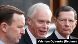 U.S. Senators Chris Murphy, Ron Johnson, and John Barrasso attend a news briefing following their meeting with Ukrainian President Volodymyr Zelenskiy in Kyiv on February 14. 