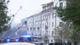 Firefighters work at the site of a drone strike in Dnipro.