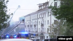 Firefighters work at the site of a drone strike in Dnipro.