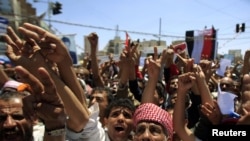 Antigovernment protesters shout slogans during a rally to demand the ouster of Yemen's President Ali Abdullah Saleh in Sanaa in late September.