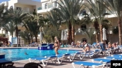 EGYPT -- Tourists enjoy their time off at the pool of a hotel in Red Sea resort of Hurghada, January 9 2016. 