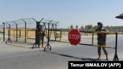 Uzbek soldiers near Termez guard a checkpoint on August 15, two kilometers from a bridge over the Amu Darya River that separates Uzbekistan and Afghanistan.