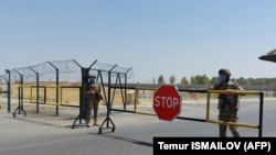 Uzbek soldiers guard a checkpoint near the Uzbek-Afghan border near Termez. 