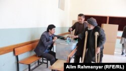 An elderly Afghan voter casts his ballot in the northren Jawzjan Province on October 20.